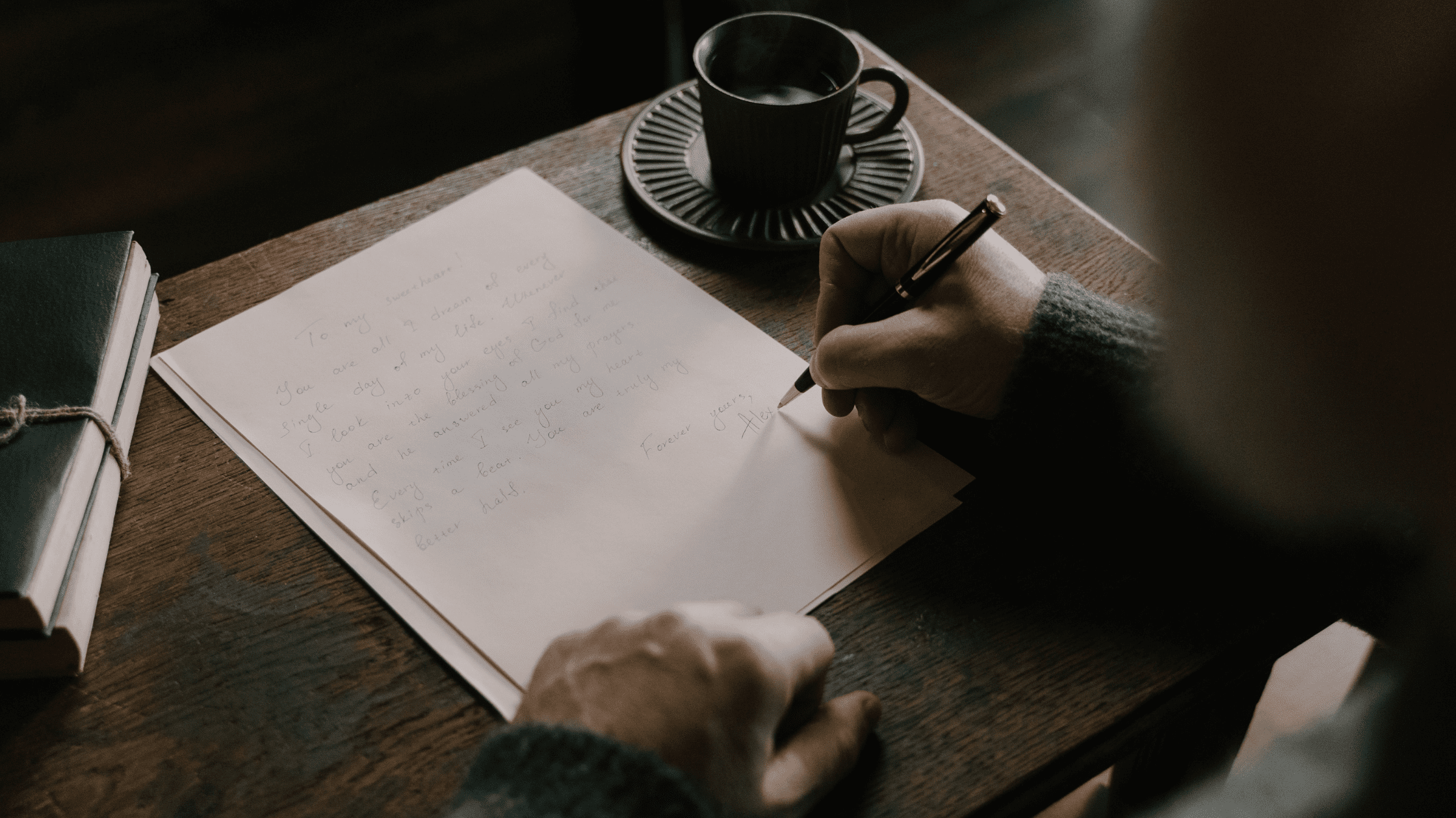 A person sitting at a desk writing a Residency Thank You Letter